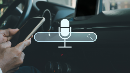 A microphone icon over a search bar symbolizing the topic of voice search optimization