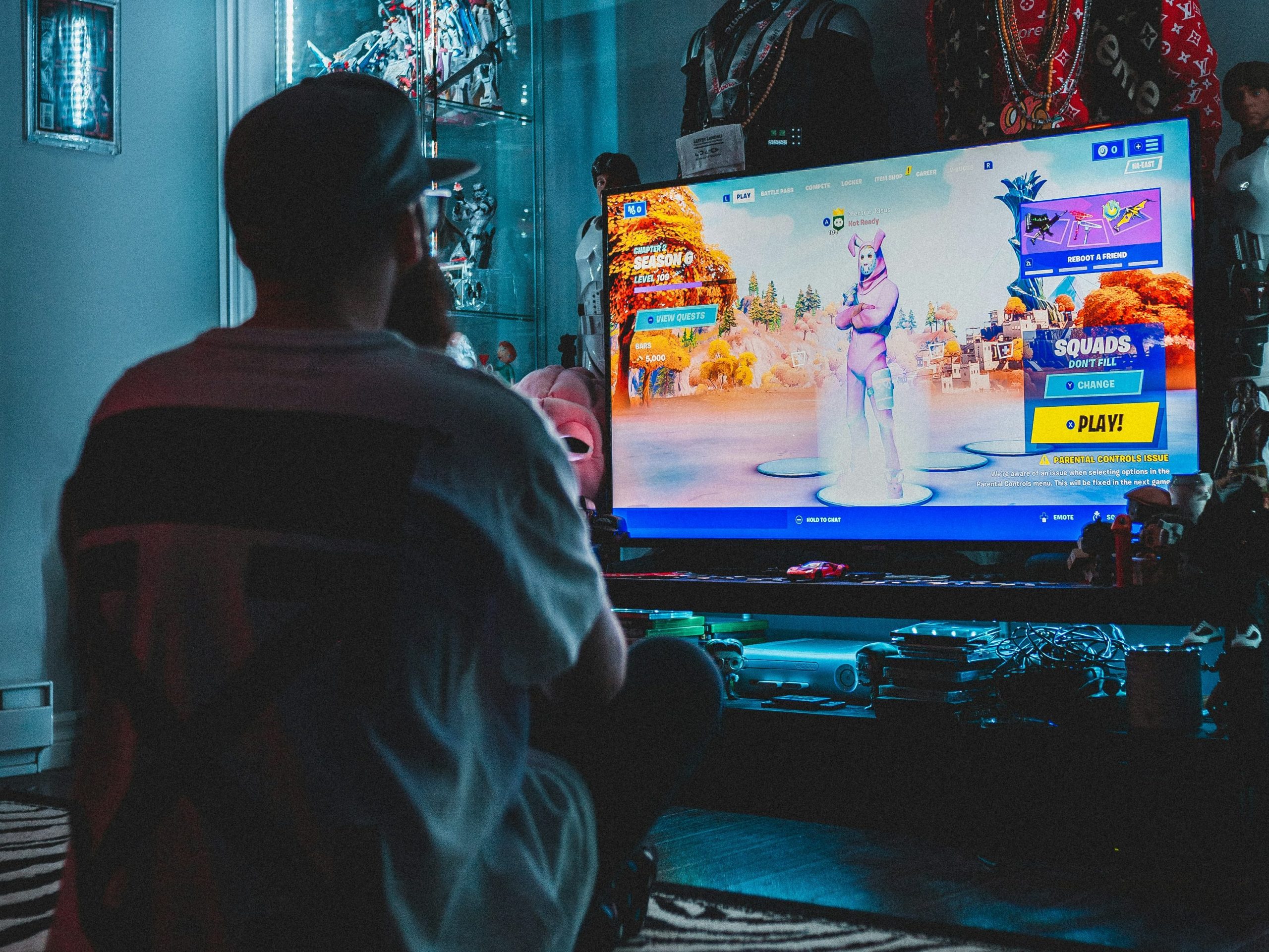 Person playing Fortnite in a dark room